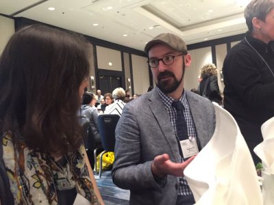 Neag doctoral student, T.J. McKenna, discusses research with conference attendee.