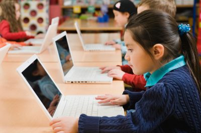 Schoolchildren using computers.