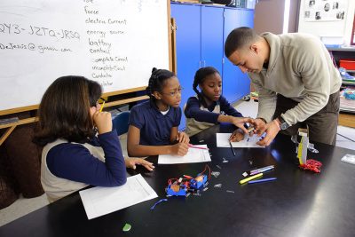 Fourth-graders working on experiment with teacher