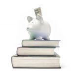 Piggy bank on top of stack of books.