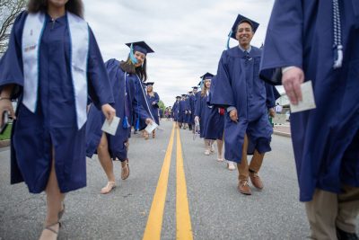 Class of 2018 Neag School grads walk up Glenbrook Road to the Jorgensen Center for the Performing Arts. (Photo credit: Frank Zappulla/Neag School)