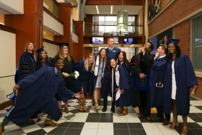 Students and faculty in the Gentry Building prior to the Undergraduate Commencement ceremony. (Photo credit: Cat Boyce)