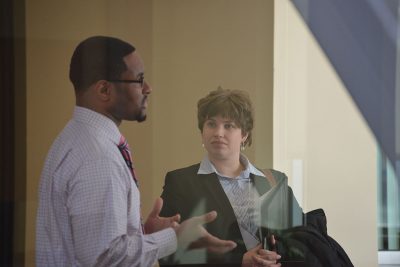 Emily Tarconish listens in while Assistant Professor Joseph Cooper speaks with a small group. (Stefanie Dion Jones/Neag School)