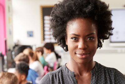 Black female leading a classroom.