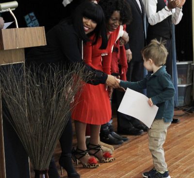 Jamie Baker recognizes a student for good behavior at Ross/Woodward School