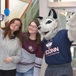 Students take a selfie with Jonathan the Husky at the Gentry Building during UConn’s Giving Day in March.