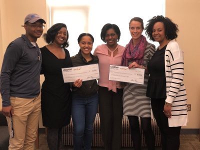Dean Gladis Kersaint, third from right, gathers with (from left) IB/M student Kyre McBroom; Dominique Battle-Lawson, academic advisor; Anne Denerville ’18 (ED), ’19 MA; Danielle DeRosa, program coordinator with Husky Sport; and Mia Hines, academic advisor, to celebrate L.I.D. and Husky Sport’s first-place showing in this year’s Ignite campaign.