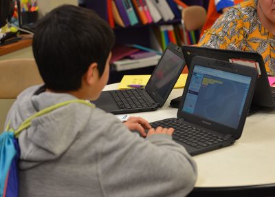 Student looking at computer.