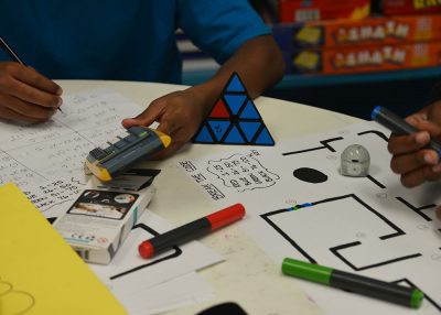 Young students working with computer coding materials.