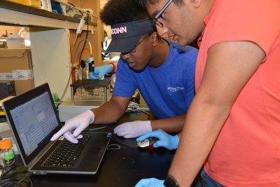 Two students from the Jack Kent Cooke Foundation’s Young Scholars Senior Summit examine computer data as part of their research project. 