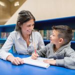 Teacher with a student at the library