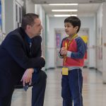 Daniel J. Crispino with elementary school student.