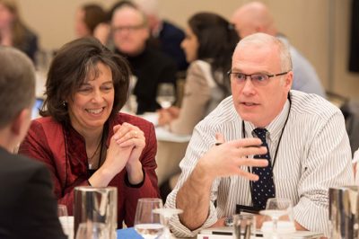 Superintendent of the Year Paul Freeman meets with Kelly Lyman at event.