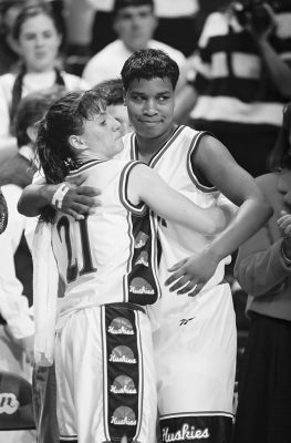 Jennifer Rizzotti and Jamelle Elliott hug on the court.