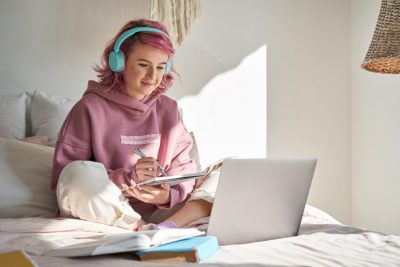 Young female student studying with laptop. A new study examined the impact of online learning during Spring 2020 on college students with disabilities.