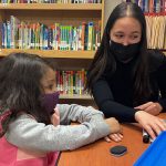 Isabella Gradante works with young student.