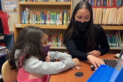 Isabella Gradante works with young student.