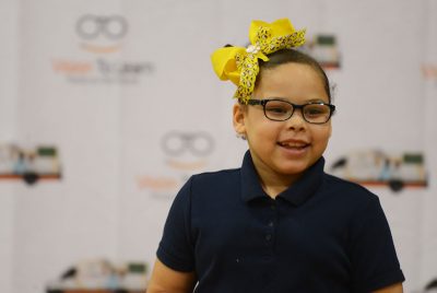 A’miyah Diaz smiles wearing her new eyeglasses as she runs back to her parents.